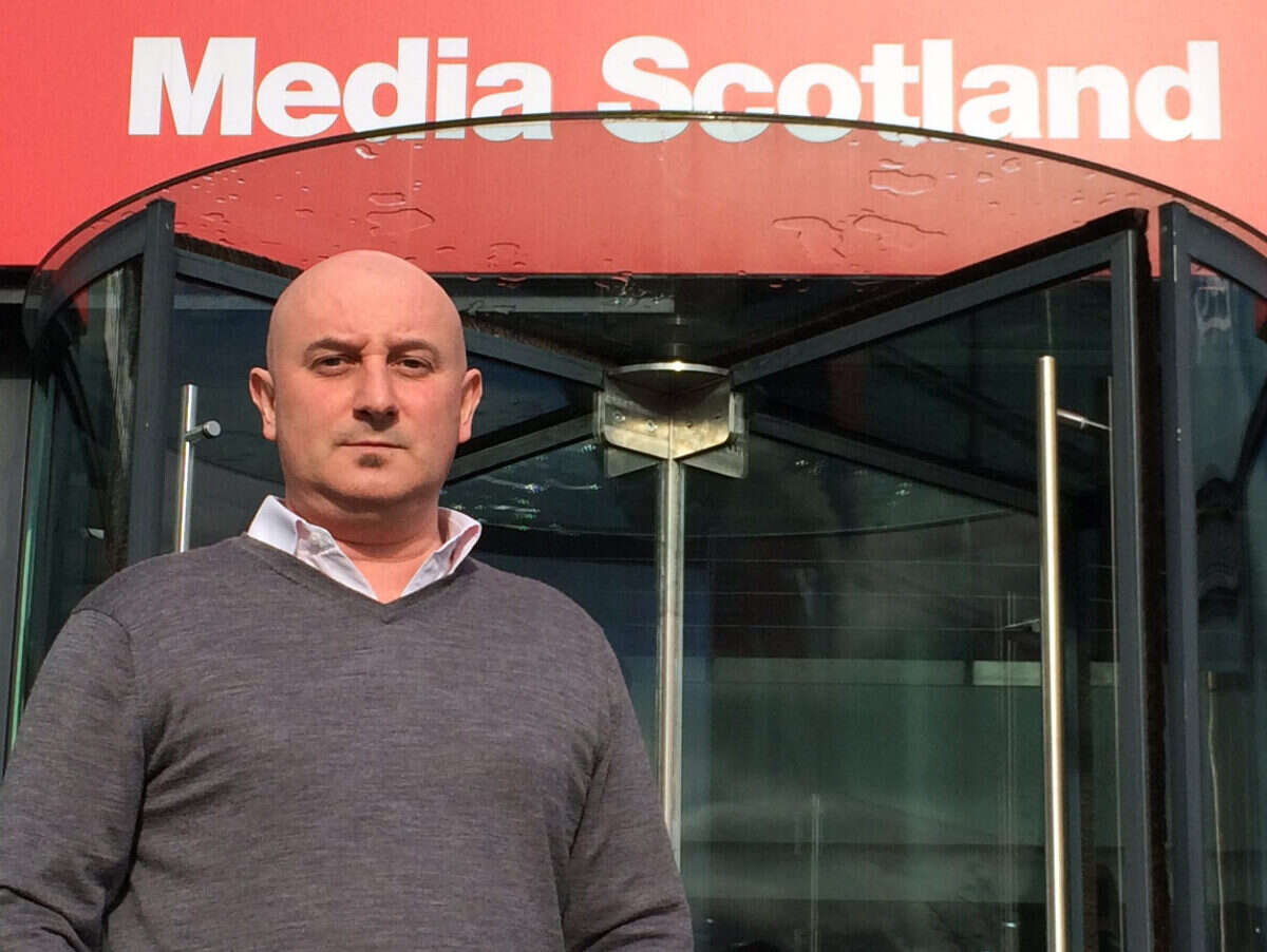 David Dick in front of 'Media Scotland' signage