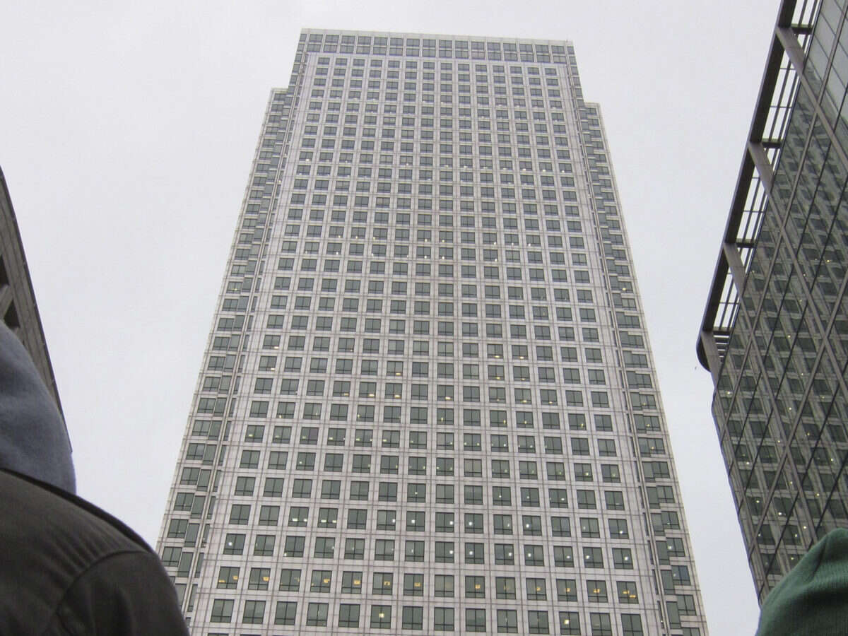 Reach headquarters in Canary Wharf - picture shows skyscraper taken from bottom, with grey sky behind