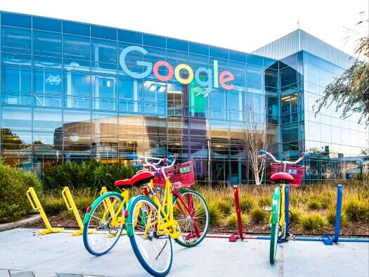 Google headquarters - big glass building with Google sign on it and bikes parked in front