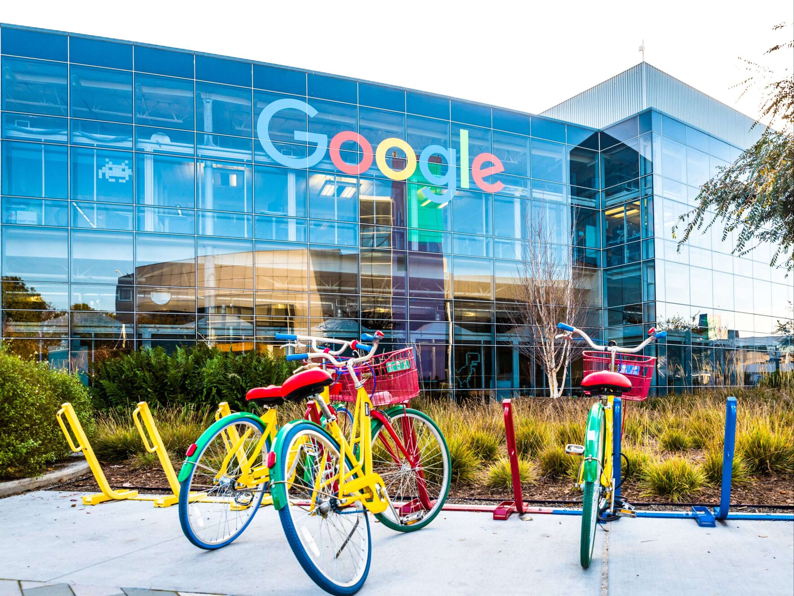 Google headquarters - big glass building with Google sign on it and bikes parked in front