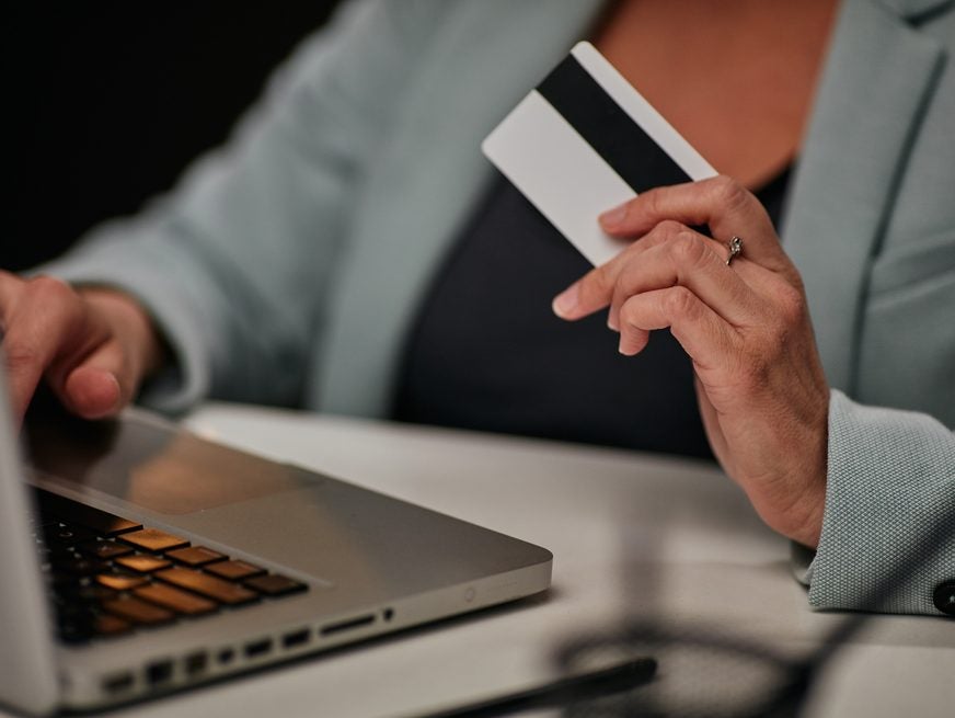 Woman paying credit card laptop stock image