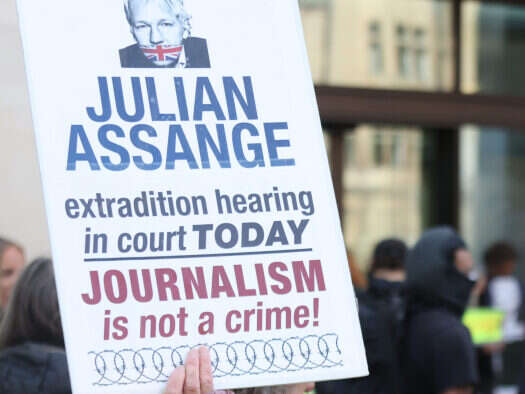 Julian Assange sign outside court