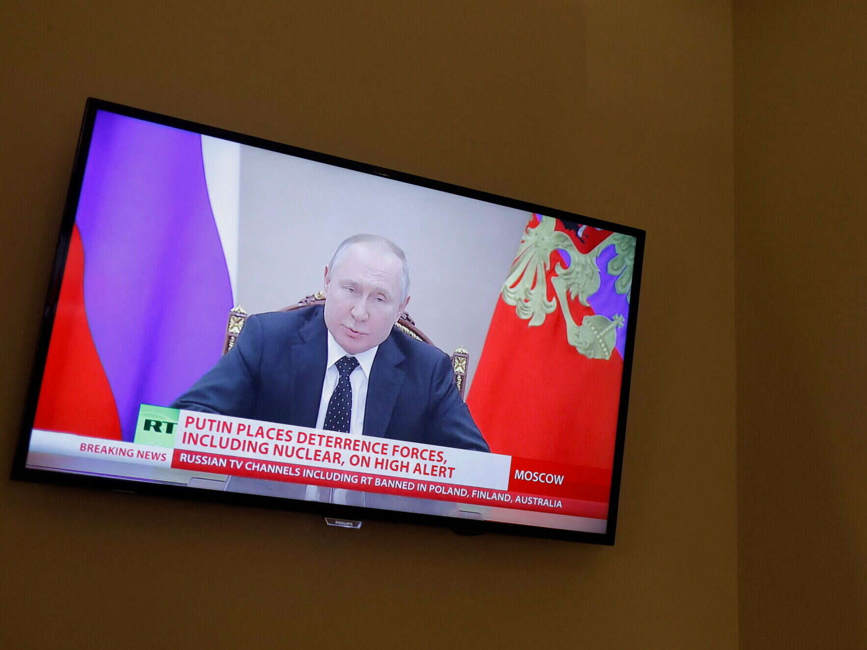 Vladimir Putin appears on an RT broadcast, illustrating a story about Russia banning more UK journalists from the country