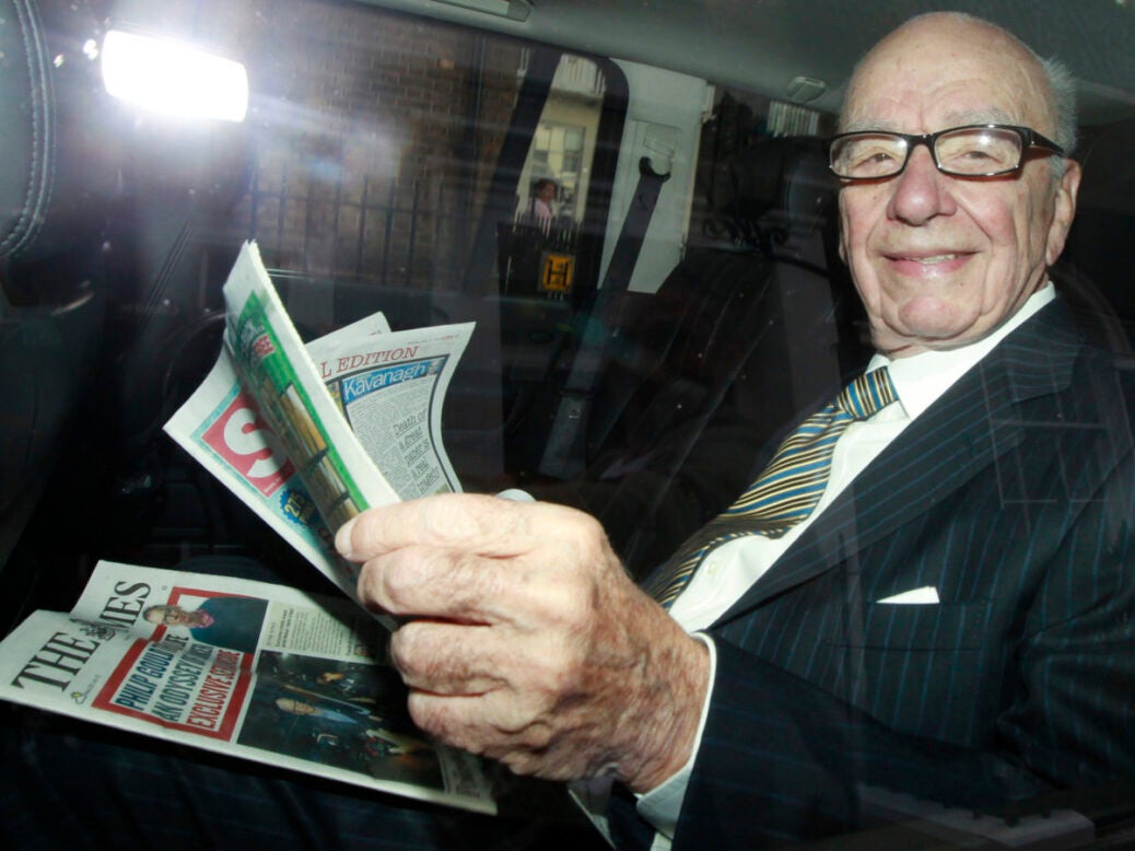 Rupert Murdoch in a taxi reading The Sun