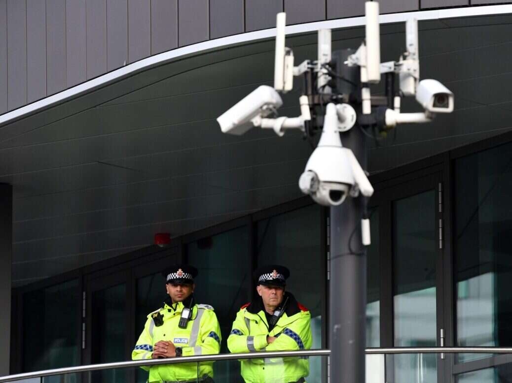 police arrest journalists? not in this picture. this is a picture of two journalists gazing out from a balcony