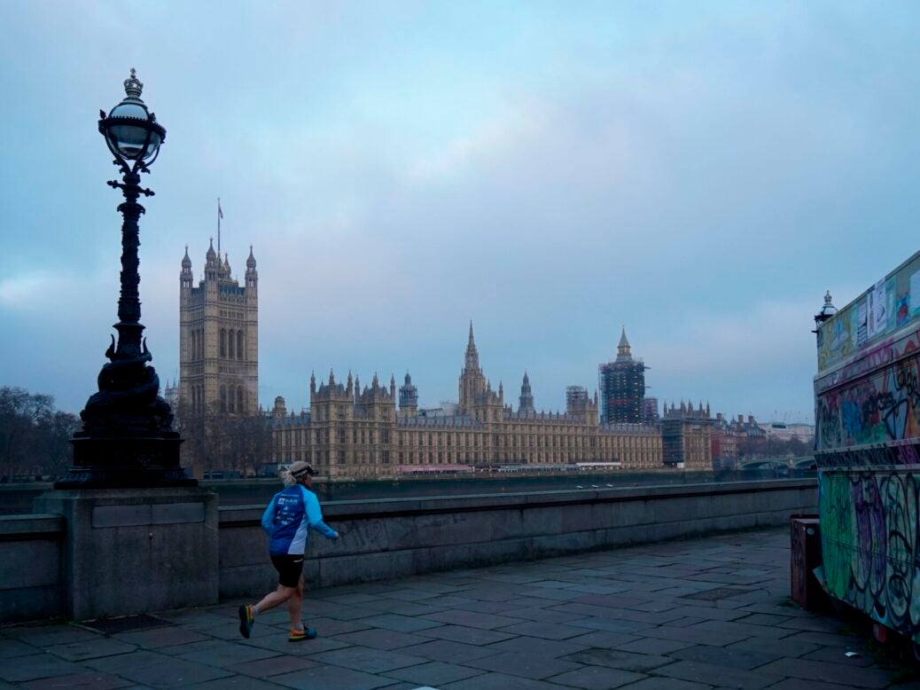 Media bill Section 40 A jogger runs along the southern bank of the Thames with the Houses of Parliament across the river at sunrise. Picture: Niklas Halle'n/AFP via Getty Images