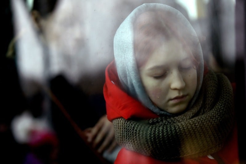 Reuters image of a young woman crying in Ukraine