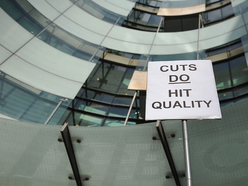 A BBC employee holds a placard outside Broadcasting House in central London on February 18, 2013, as he mans a picket line during a strike over compulsory redundancies.Today February 18, 2013, BBC journalists began a 24-hour strike in protest at compulsory redundancies, causing possible disruption to the broadcaster's television and radio output. Members of the National Union of Journalists (NUJ) walked out at midnight (local time and GMT) at the end of Sunday's programming, over job cuts which are expected to affect BBC Scotland, Five Live, the Asian Network and the World Service. AFP PHOTO / CARL COURT (Photo credit should read CARL COURT/AFP via Getty Images)