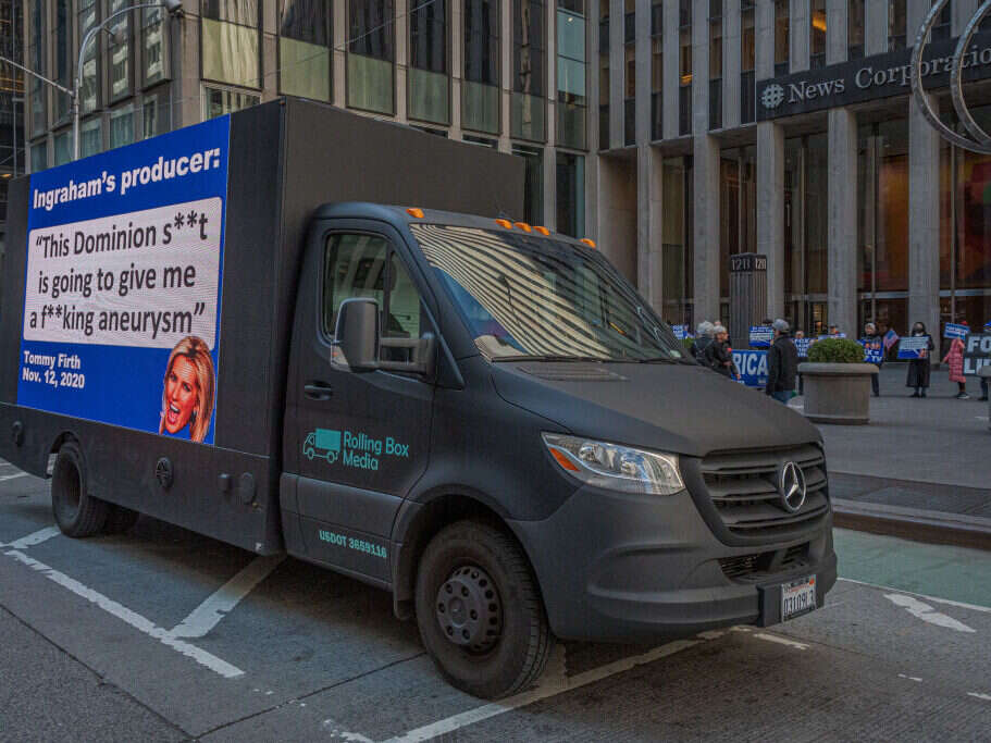 A billboard truck outside Fox News HQ in New York City. The display quotes Fox host Laura Ingraham's producer, Tommy Firth, saying: "This Dominion shit is going to give me a fucking aneurysm".