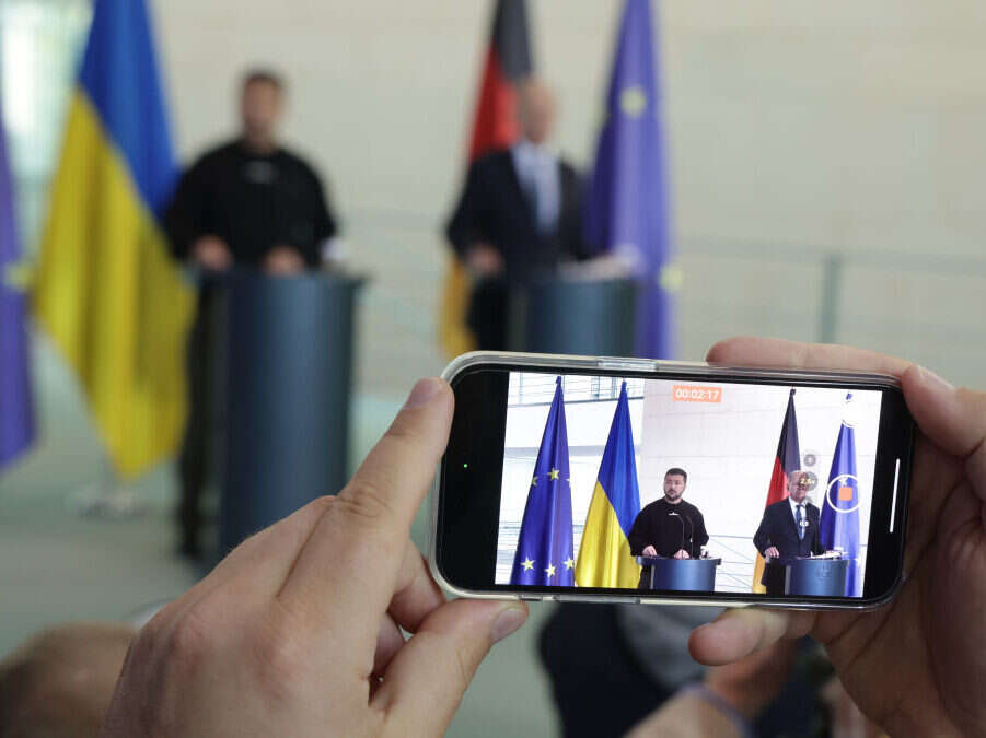 A reporter films German Chancellor Olaf Scholz and Ukrainian President Volodomyr Zelensky speaking to the media in May 2023 in Berlin. This article is about the state of local media in Ukraine.