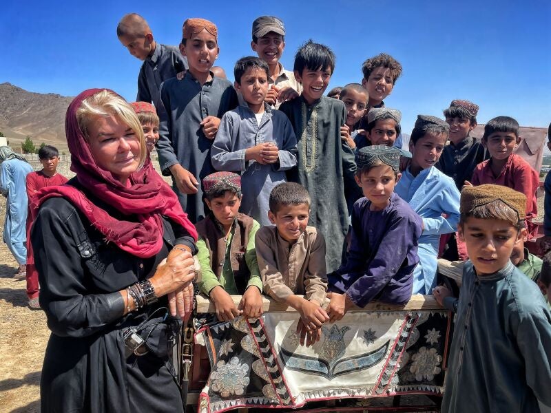 Alex Crawford in Afghanistan in 2022 with a group of children