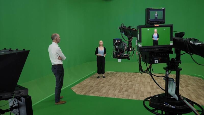 Sky News science and technology editor Tom Clarke and producer Hanna Schnitzer creating the AI reporter