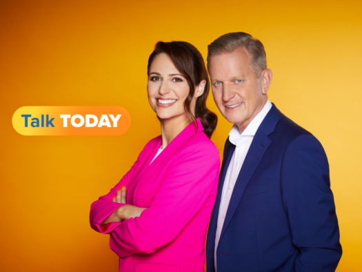Nicola Thorp and Jeremy Kyle, the hosts of TalkTV's new breakfast programme Talk Today, stand together looking side-on at the camera against an orange background. Kyle has told Press Gazette that "the world has moved on" from his daytime television programme, The Jeremy Kyle Show, which was cancelled in May 2019 following the death of a guest.