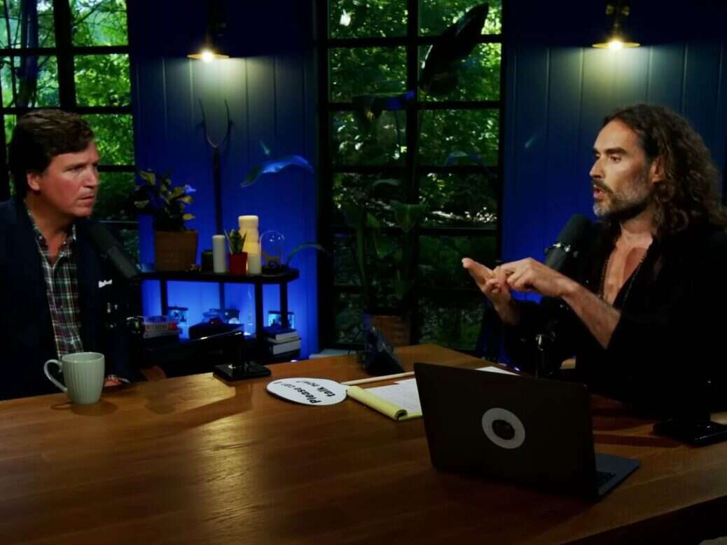 Russell Brand pictured interviewing Tucker Carlson on his Youtube show.