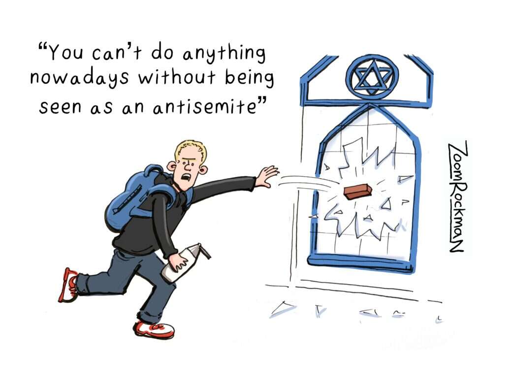 A cartoon by Zoom Rockman for Private Eye, depicting a man throwing a brick through a window at a building decorated with the Star of David. The man, who wears a hoodie and also carries a spray paint can, is saying: "You can't do anything nowadays without being seen as an anti-Semite."