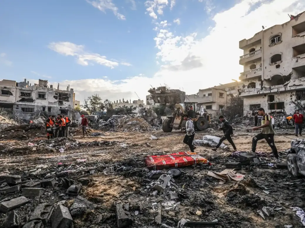 The Palestinian Civil Defense searches for survivors in a house for the Mukhaimir family and neighboring houses after an Israeli raid in the city of Rafah, south of the Gaza Strip, on October 17 2023. (Shutterstock)