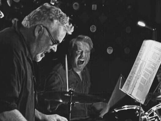 Richard Browning, left, playing live with his band