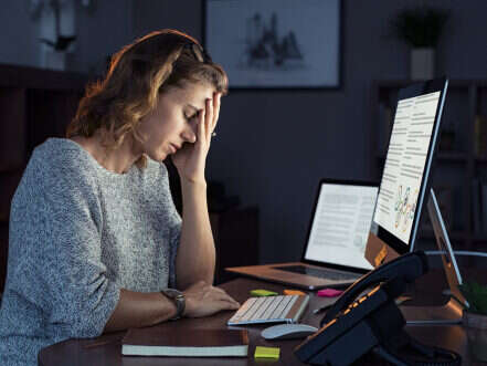 Woman at desk suffering burnout or poor mental health