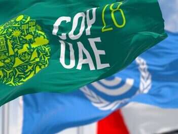 Dubai, UAE, Nov. 30 2023: Flags of COP28, UNFCCC and UAE waving on a clear day.
