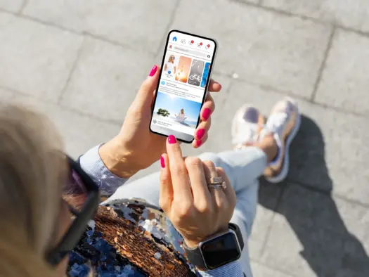 A woman scrolls Facebook on her phone. Picture: Shutterstock/Kaspars Grinvalds