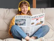 Young person reading a newspaper. Picture: Shutterstock/Pixel-Shot