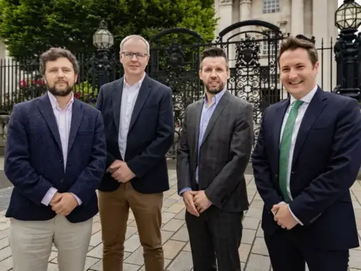 Belfast Telegraph/Sunday Independent Northern Ireland editor Sam McBride, Irish News assistant editor Aeneas Bonner, Belfast Telegraph deputy editor-in-chief Martin Breen and solicitor Fergal McGoldrick standing in a line dressed in suits outside the High Court in Belfast on 31 May 2024. Picture: Kevin Scott
