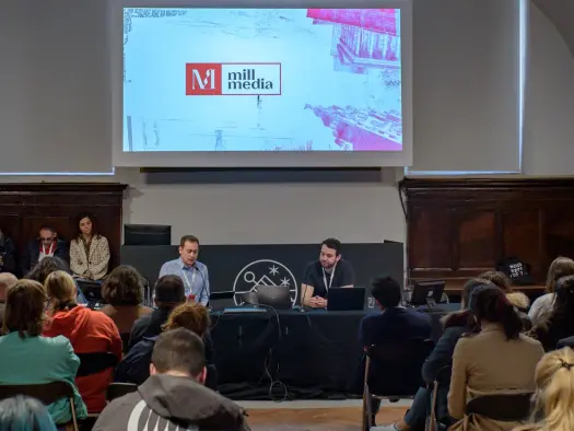 Mill Media founder Joshi Herrmann is pictured giving a presentation at the Perugia journalism festival, illustrating a story about the publisher hiring for 11 new roles as it expands into London and Glasgow.