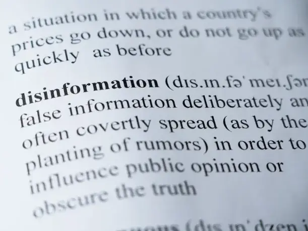 Close-up of dictionary definition of disinformation