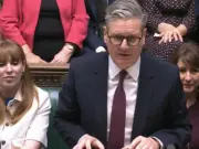 Keir Starmer standing and speaking at House of Commons despatch box with Angela Rayner sitting to his left and Rachel Reeves on his right