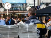 Distributors are pictured handing out copies of the Evening Standard, illustrating a story about the company's final accounts as a daily newspaper in 2023/24, when it lost nearly £20m but purportedly saw a significant improvement after going weekly.
