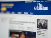 A computer screen displaying The Guardian home page is seen in partial profile, with the nearer part of the screen displaying the publisher's logo in focus and further away parts of the screen blurry. The image illustrates news that The Guardian has concluded the voluntary redundancy round it opened in May and has resulted in the departure of several prominent journalists, including media editor Jim Waterson and special projects editor (and originator of the Guardian Long Read) Jonathan Shainin.