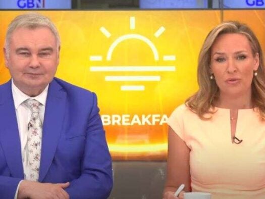 RAJAR Q2 2024 winners GB News' Eamonn Holmes and Isabel Webster dressed in smart clothes sitting side by side looking at the camera with a sunshine logo and the word breakfast displayed behind them