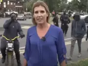 Sky News communities correspondent Becky Johnson as masked men approach her while live on-air in Birmingham on Monday 5 August. Picture: Sky News/Youtube screenshot