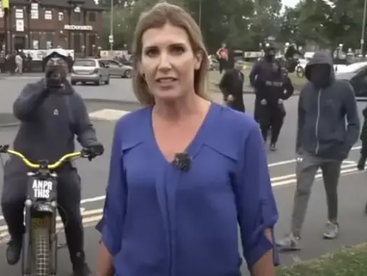 Sky News communities correspondent Becky Johnson as masked men approach her while live on-air in Birmingham on Monday 5 August. Picture: Sky News/Youtube screenshot