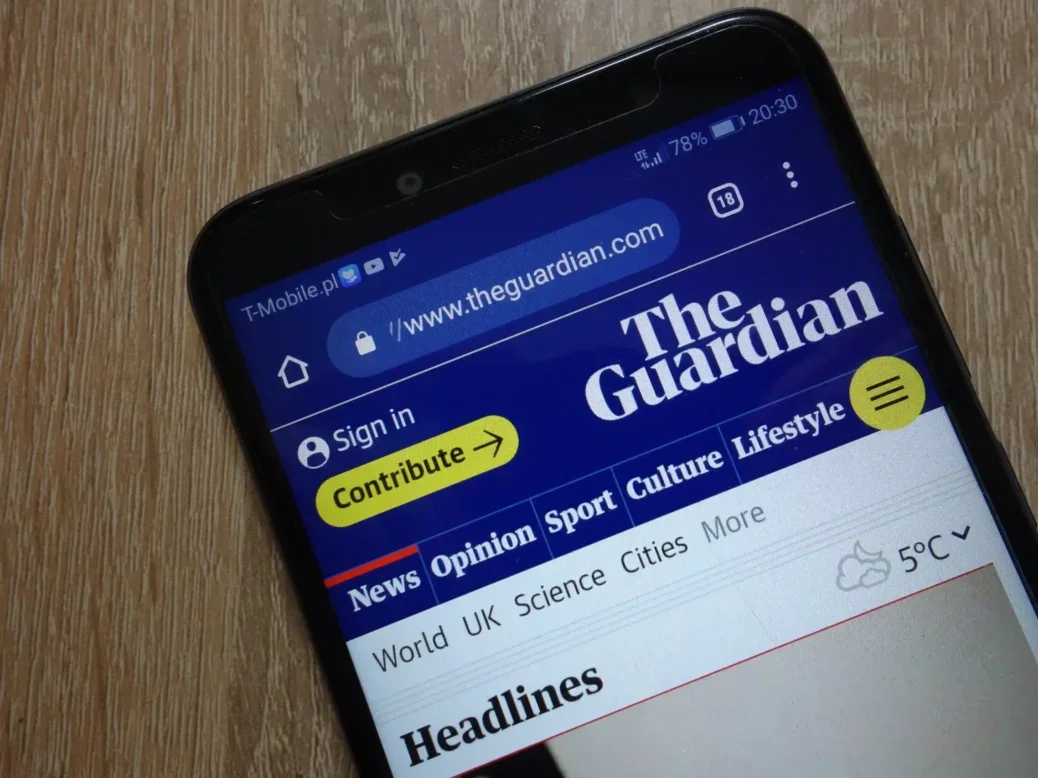 The Guardian website displayed on smartphone, illustrating a story about The Guardian leaving X/Twitter