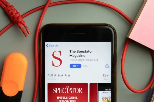 The Spectator Magazine app store is seen on a phone screen, illustrating a story about Paul Marshall's successful acquisition of the magazine. Marshall has vowed to fix "underinvestment" in the title.