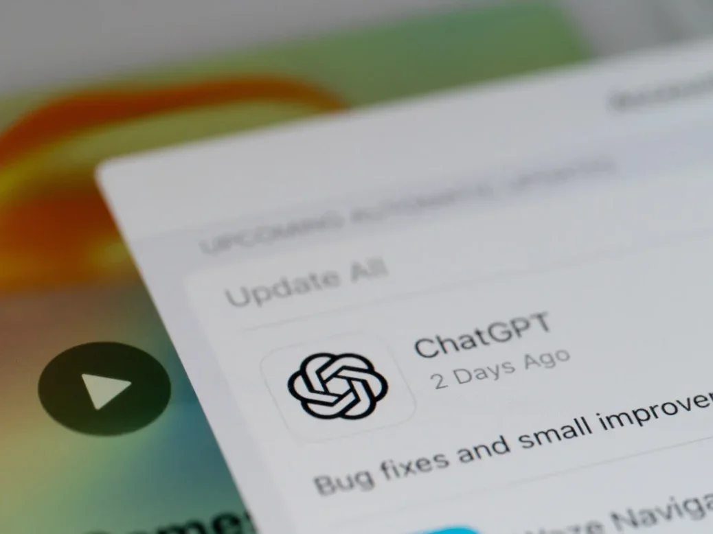 A close up view of the ChatGPT app updating on an iPhone screen, illustrating a story about increasing referral traffic from AI platforms ChatGPT and Perplexity to news sites