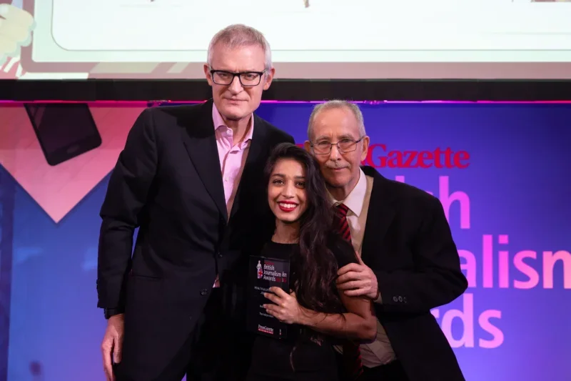 The Independent's Rebecca Thomas picks up the Health & Life Sciences Journalism prize at the British Journalism Awards 2024 from Jeremy Vine and judge Brian Deer. Picture: ASV Photography/Press Gazette