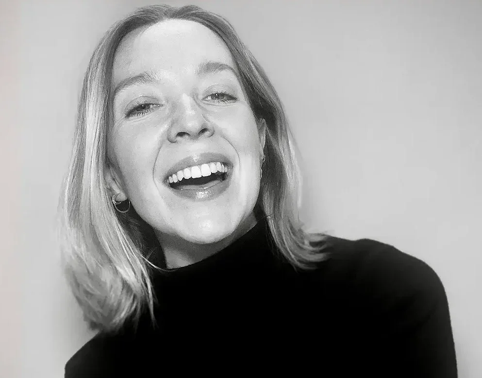 Black and white photo of Ellen Stewart laughing