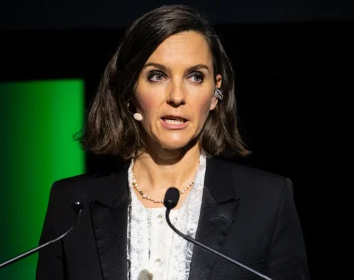 Channel 4 CEO Alex Mahon standing at a podium speaking into a microphone