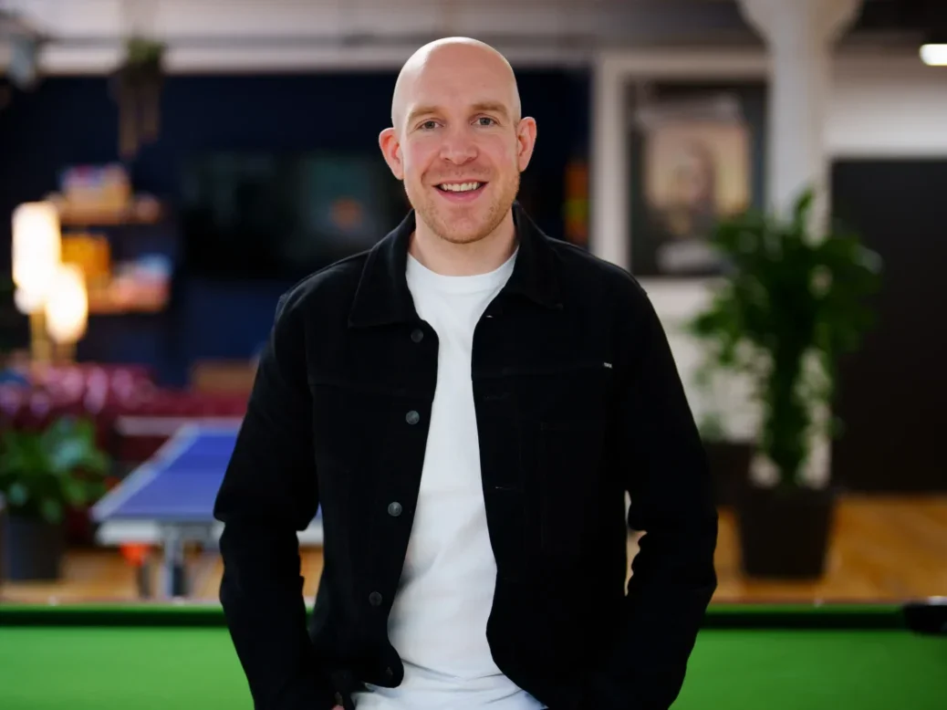 LBG Media CEO Solly Solomou standing in the company's office in front of a pool table