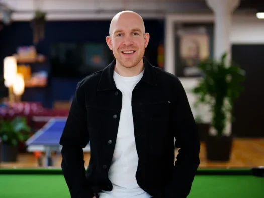 LBG Media CEO Solly Solomou standing in the company's office in front of a pool table