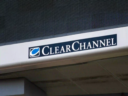 A Clear Channel sign on an outdoor digital billboard in San Jose, California, USA - 2020. The image illustrates the news that Bauer Media Group has agreed to acquire the northern European operations of Clear Channel.