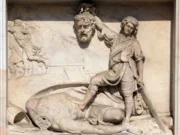 David with the Head of Goliath, marble relief on the facade of the Milan Cathedral, Duomo di Santa Maria Nascente, Milan, Lombardy, Italy. Shutterstock