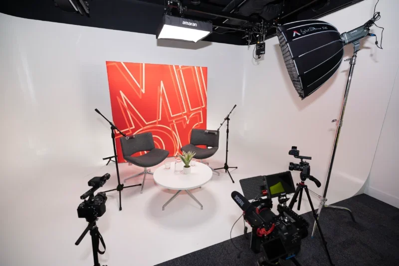 Large video studio set up for two people to sit in front of a Mirror branded screen