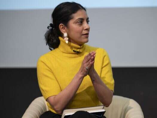 Mitali Mukherjee, the acting director of the Reuters Institute for the Study of Journalism, appears on stage at the Society of Editors Media Freedom conference in London in 2025. She is wearing a yellow turtleneck jumper and is sat with her hands vertically flat together in front of her, pointing up and out toward the audience while she doles out "tough love" to the news industry about its loss of connection to its audience. The same event saw publishers speak about their fears over what AI will do to their connection to audiences and what they can do, or are doing, to win trust and loyalty back.