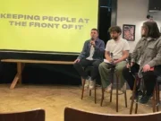 Ladbible editor Ben Smith, Joe Media editor George McKay and Metro head of social video Alex Goldsmith discussing social publishing in 2025, sitting on stools at the front of a room. Smith is speaking into a microphone and the other two are listening. Behind them is a slide saying 'keeping people at the front of it'