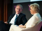 Editor-in-chief of The Atlantic Jeffrey Goldberg appears on stage at the Sir Harry Evans Investigative Journalism Summit in London in 2025 where he is being interviewed by the event's convener Tina Brown about the magazine and his so-called "Signalgate" scoop that arose when members of the Trump administration accidentally added him to a sensitive group chat. Goldberg, left, is seen in a dark suit and glasses, leaning back in a relaxed posture and appearing to laugh. Brown, right, is out of focus, wearing a cream suit and listening.