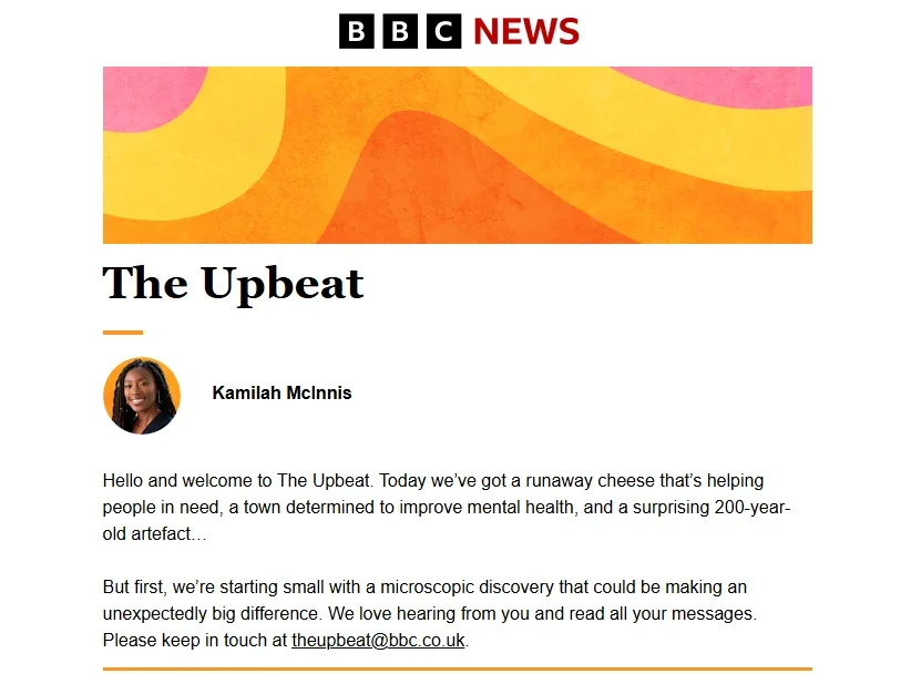 The top of a recent edition of the BBC News newsletter The Upbeat with author pic and byline for Kamilah McInnis and her intro to the stories that will appear below, including a "runaway cheese that's helping people in need"