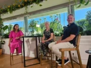 Wall Street Journal editor Emma Tucker, Joanna Coles, chief content officer and creative officer of The Daily Beast, and Vox Media CEO Jim Bankoff at a WSJ event at Cannes Lions 2025. Bright blue sky backdrop. Three people sitting on high chairs at a high table with a WSJ logo on it.